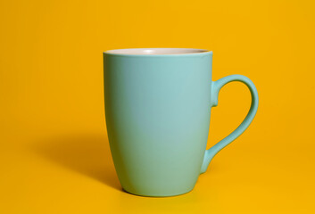 Matte blue mug on yellow background