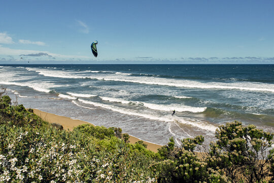 Man kitesurfing at a surf beach