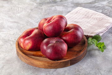 Ripe sweet juicy flat nectarines heap