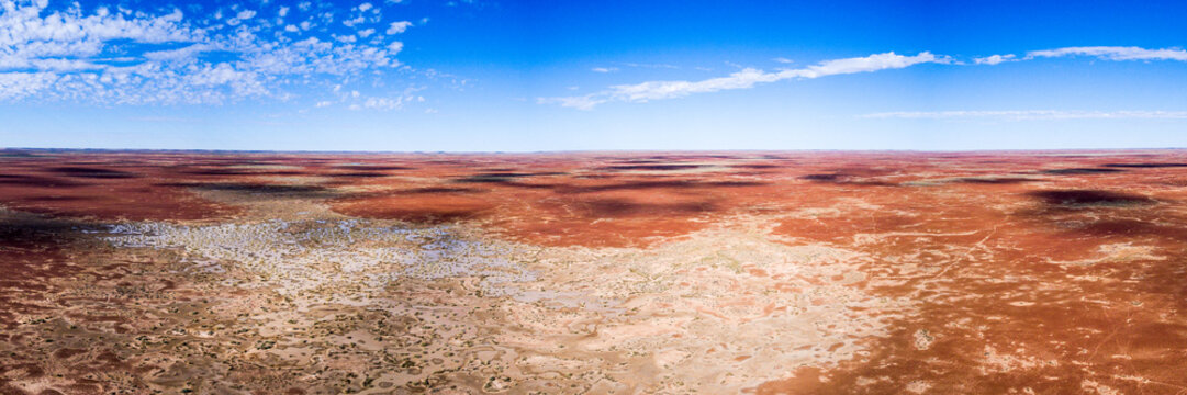 Red outback land against blue sky