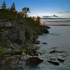 Sunset at stony shore of Ladoga lake