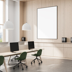 Blank poster mockup on wooden wall in modern office interior with green chairs, pendant lights, and...