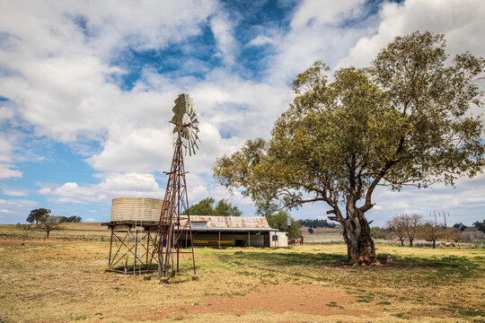 Windpump (windmill), water tank and haystack barn on a dry farmland property