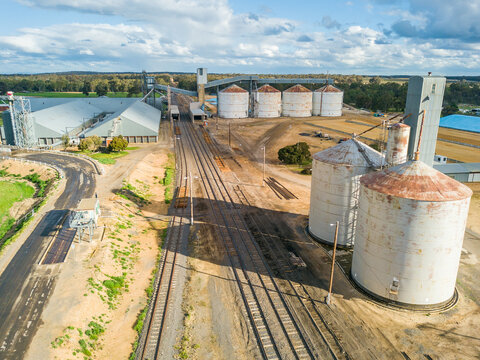 Looking down on roads and railways lines running to a collection of grain silos