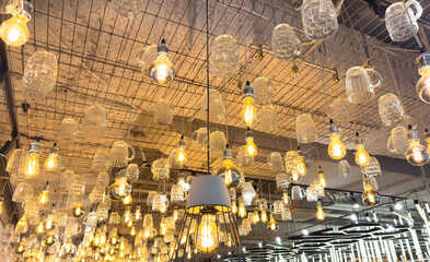 A series of lights hanging from the ceiling, some of which are lit up