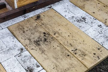 Finishing works on laying paving stones in the garden, pouring sand under the paving stones,