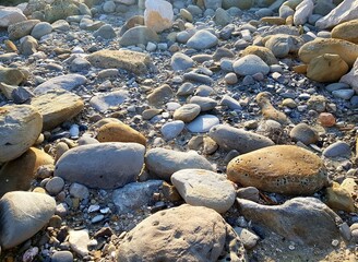 Rocks and pebbles on the seashore, closeup of photo