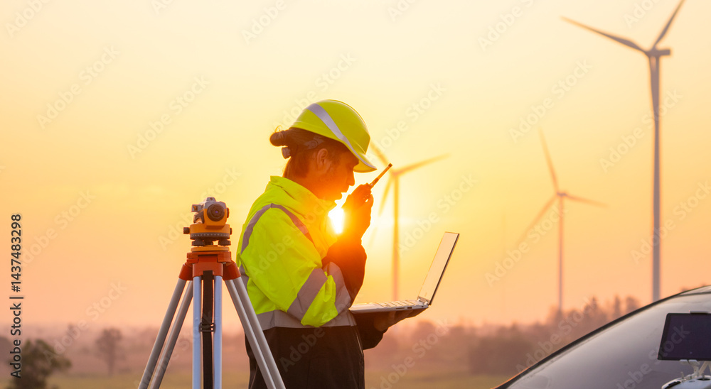 Leinwandbilder engineer working on laptop in front of wind turbines for checking wind turbines of the field during 