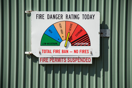 Total fire ban no fires and fire permits suspended sign on fire danger rating sign