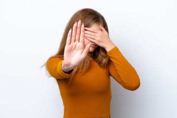 Teenager Russian girl isolated on white background making stop gesture and covering face