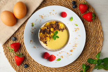 Mango pudding with chocolate and fresh fruit. Top view table.