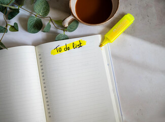 Planner notebook and cup of coffee on shadows background  .To do list 