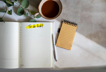 Planner notebook and cup of coffee on shadows background  .To do list 