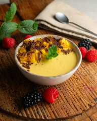Mango pudding with chocolate and fresh fruit.