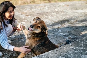 Happy Woman Hugging her Adopted Stray Dog 