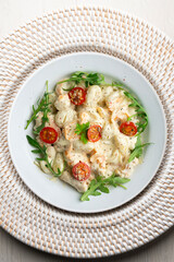 Italian gnocchi salad with cream and arugula. Top view table.