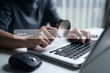 Search data and SEO technology, Hand typing on laptop keyboard and holding magnifying glass searching for information on the website. Online networking system, Using Search Console with website