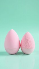 Pair of pristine beauty blenders against a refreshing mint and white backdrop,  smooth,  studio