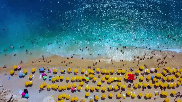 Antalya, August 2024:People sunbathe and swim at Kaputaş beach in Turkey on the Mediterranean coast.A beach with turquoise sea waters from a bird's-eye view, between the towns of Kash and Kalkan.Drone