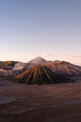 Fototapeta premium Scenic view of mount bromo emitting smoke at sunrise in east java, indonesia