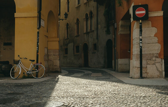 Fototapeta Streets of Verona Italy, narrow street with cobblestone pavement in old town 