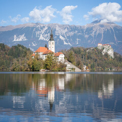 Church in the middle of lake with castle in backdrop, Bled, Slovenia, Europe