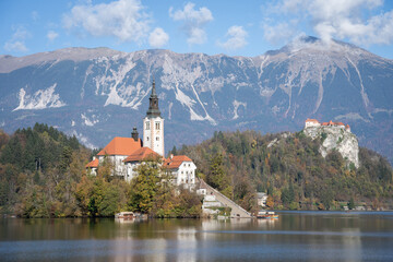 Church in the middle of lake with castle in backdrop, Bled, Slovenia, Europe
