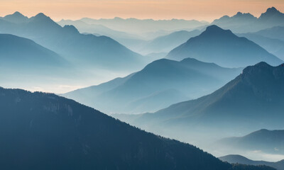 Fototapeta premium A breathtaking view of a mountain range during sunset with vibrant colors and clouds