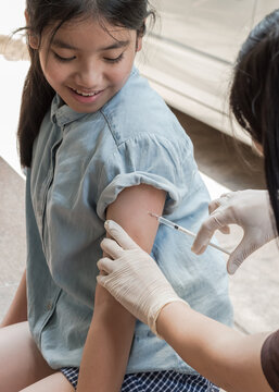 Vaccine for HPV vaccination in Asian girl, flu shot injection or medical immunization for prevention against influenza virus pandemic disease, coronavirus, covid-19, cervical cancer or measles