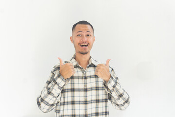 Fototapeta premium Young asian men with flannel is giving thumbs up with happy in isolated white background