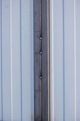 close-up of a man painting metal black with a brush.painting.