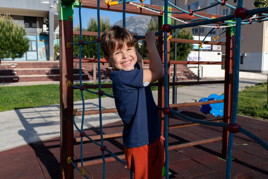 A child with diabetes playing on a playground, wearing a glucose monitor on the arm.