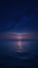Calm sea reflecting sunset colors under dark starry night sky with serene mood
