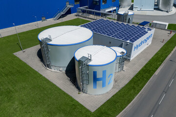 Aerial view of green hydrogen factory with storages. Hydrogen production from renewable energy...