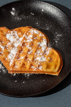 heart shaped waffles on a dark plate. Waffle day. baked waffles
