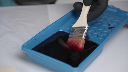 Preparing Paint Using a Brush in a Tray for Various Artistic Applications and Projects. Creative