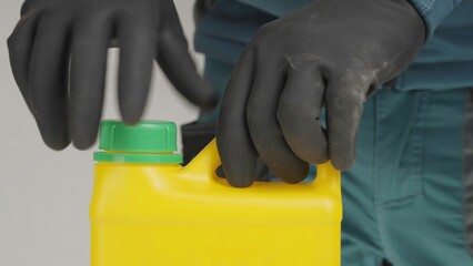 A man opens a yellow container with a green lid, revealing its contents. Creative