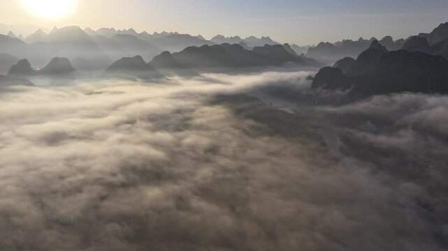 Aerial view of Wujutan along the Li River in Guilin, China, featuring a picturesque riverbank landscape with lush wetlands, sandbanks, karst mountains, and tranquil waters. Captured under clear skies.