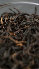 Close up of dried tea leaves in a bowl, showcasing their vibrant textures and colors. Media