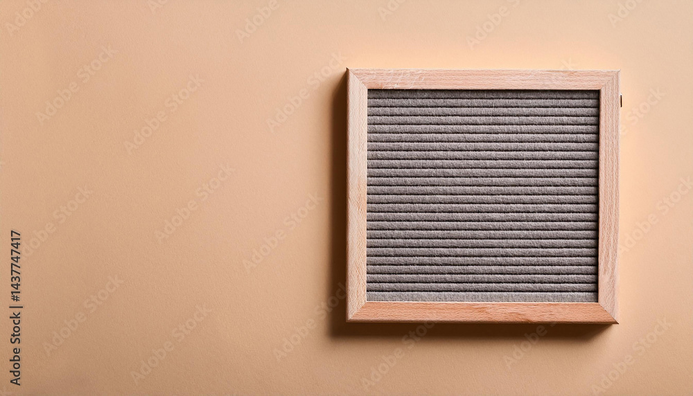 Poster empty letter board on beige wall. square frame with gray background and wood border. message area fo