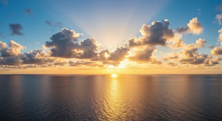 Obraz premium Bright white clouds above ocean horizon under golden sunlight