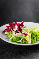 Salad mixed leaves iceberg, batavia, lettuce, radicchio, romano, frisee appetizer vegetables dish...