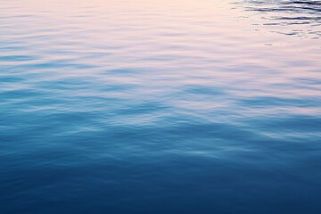 A tranquil river reflecting soft, muted hues of dawn, its surface disturbed only by faint ripples.