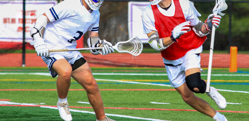 Two lacrosse players in battle during a game