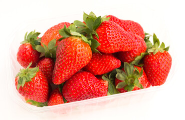 Fresh appetizing strawberries in a plastic tray onwhite background