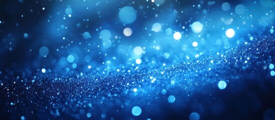 Obraz premium Blue glitter bokeh, dark background, festive
