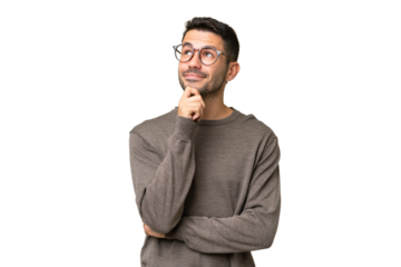 Young handsome caucasian man over isolated background thinking an idea while looking up