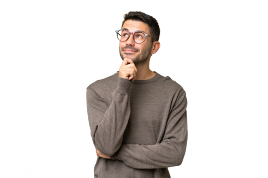 Young handsome caucasian man over isolated background thinking an idea while looking up