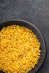 Pasta raw coquillette macaroni dish organic product fresh tasty gourmet food background on the table rustic food top view copy space