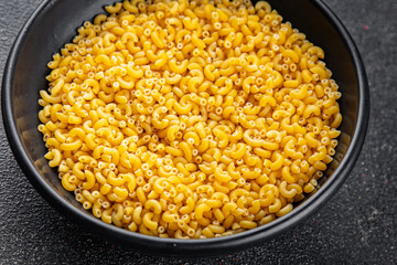 Pasta raw coquillette macaroni dish organic product fresh tasty gourmet food background on the table rustic food top view copy space